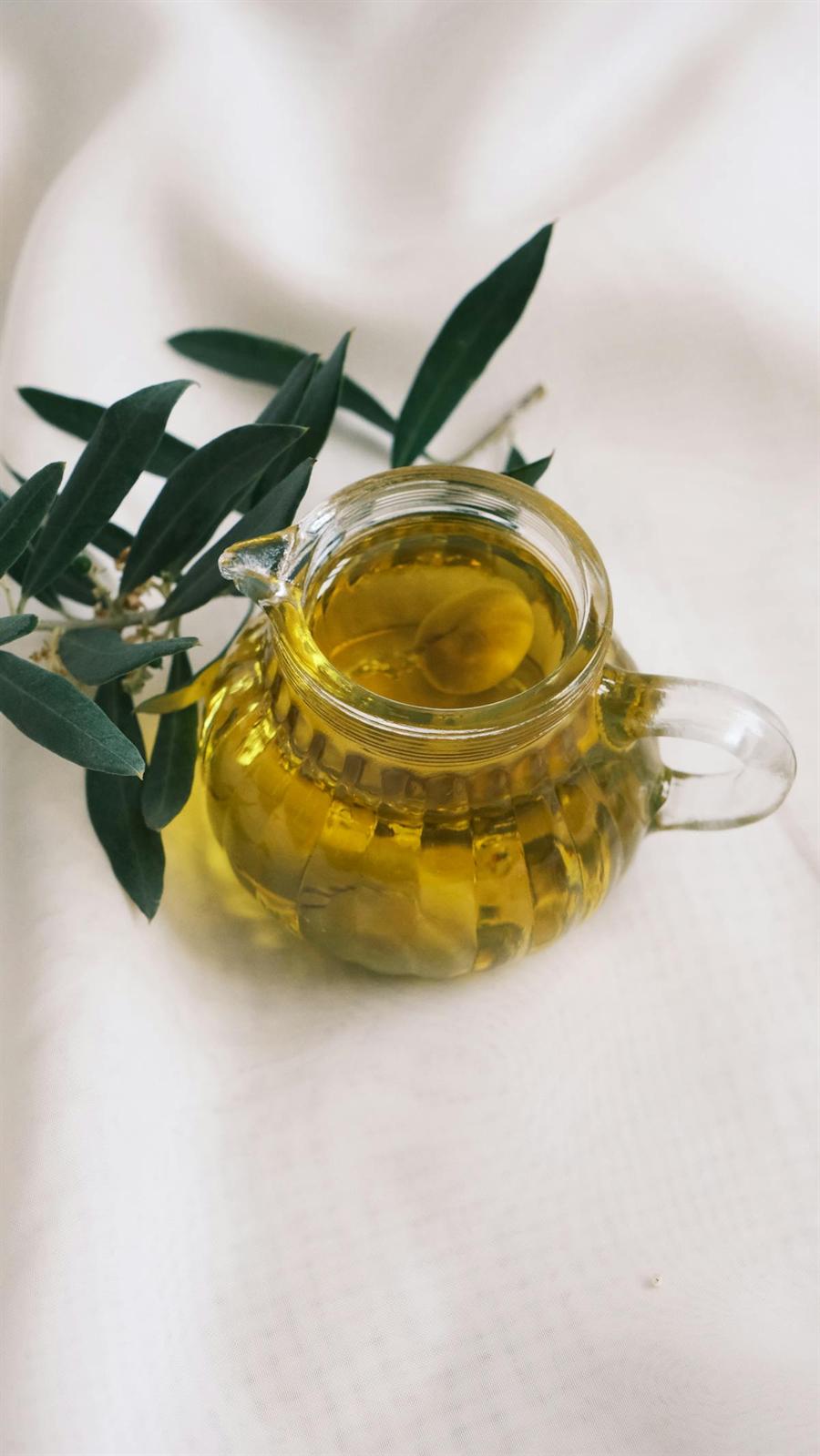 Olive oil bottle on a light background